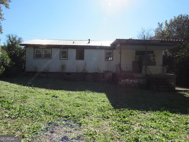 back of house with a yard