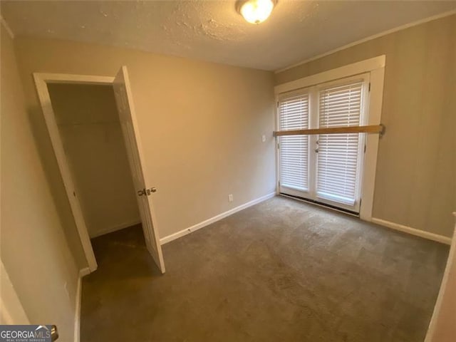 carpeted spare room featuring a textured ceiling