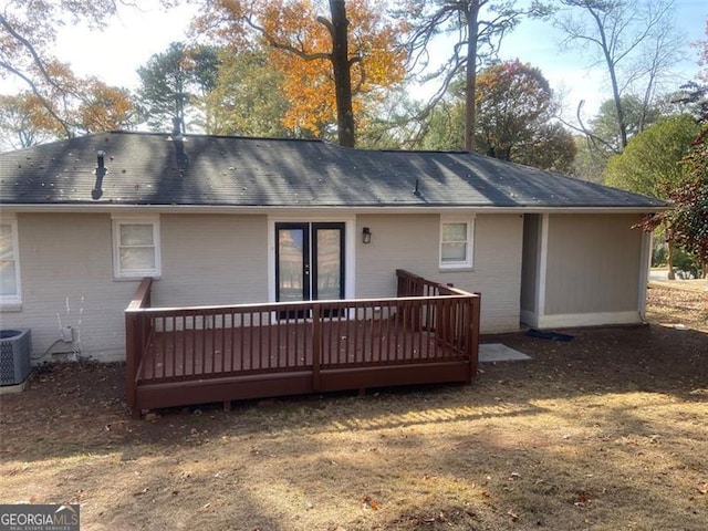 rear view of property with a wooden deck and central AC