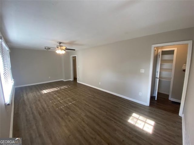 spare room featuring ceiling fan and dark hardwood / wood-style floors