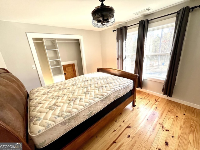 bedroom featuring wood-type flooring and a closet