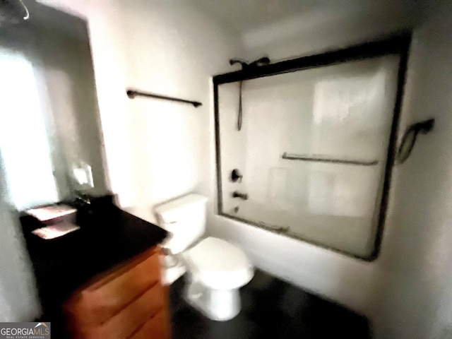 full bathroom with vanity, toilet, and bath / shower combo with glass door