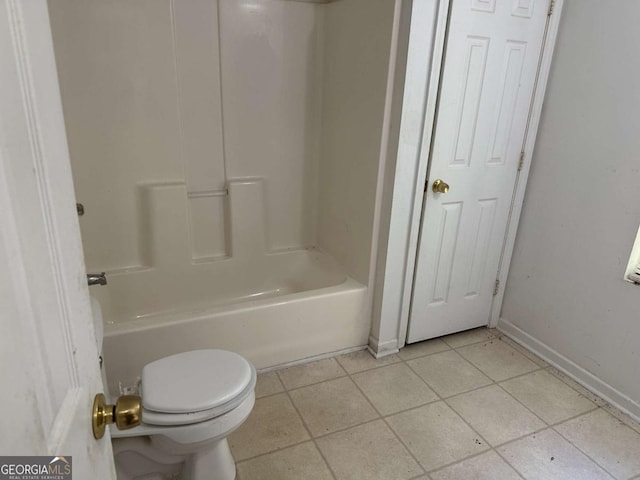 bathroom with toilet, shower / tub combination, and tile patterned floors