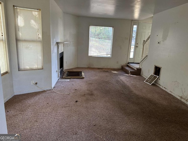 unfurnished living room featuring light carpet