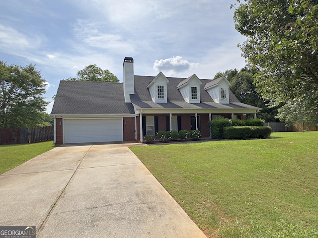 cape cod house featuring a front yard and a garage