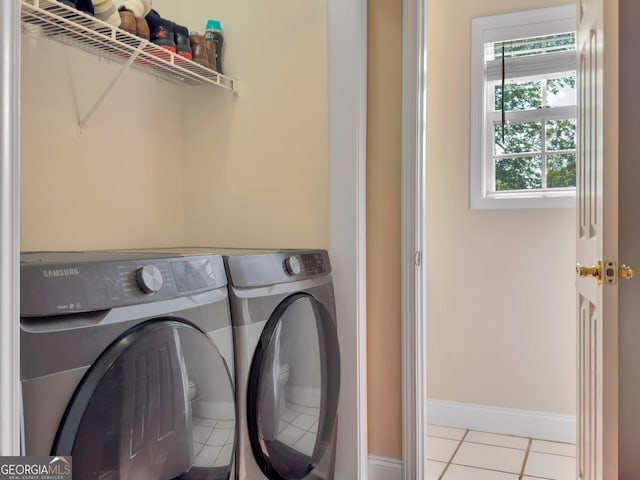 laundry room featuring light tile patterned floors and separate washer and dryer