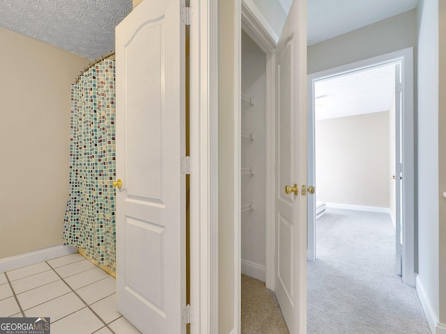 bathroom with tile patterned floors and a textured ceiling