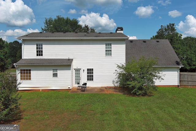 rear view of property with a lawn and a patio area