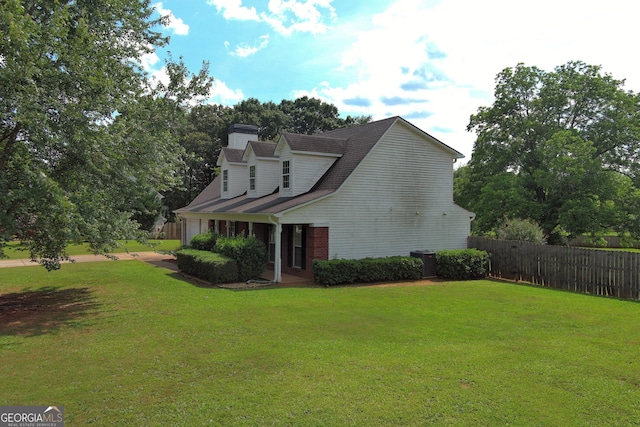 view of property exterior featuring central AC and a yard