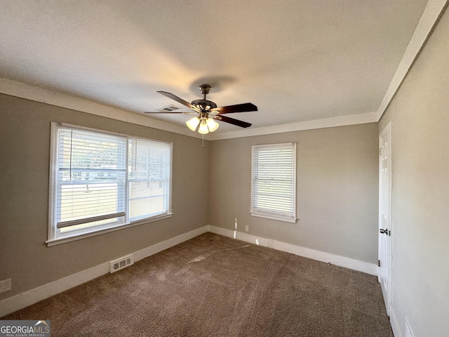 carpeted spare room with ceiling fan and a textured ceiling