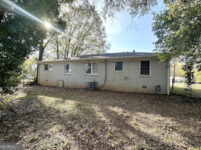 rear view of house with central air condition unit