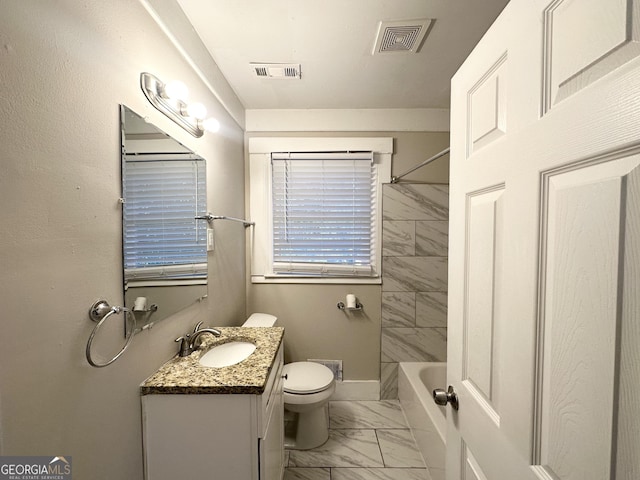 full bathroom featuring vanity, toilet, and tiled shower / bath