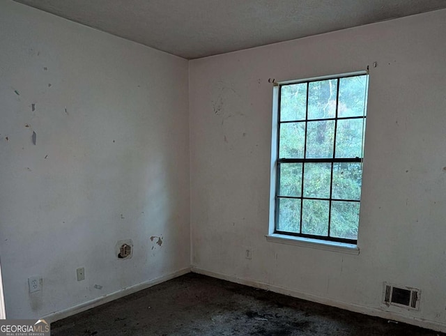 empty room featuring a textured ceiling