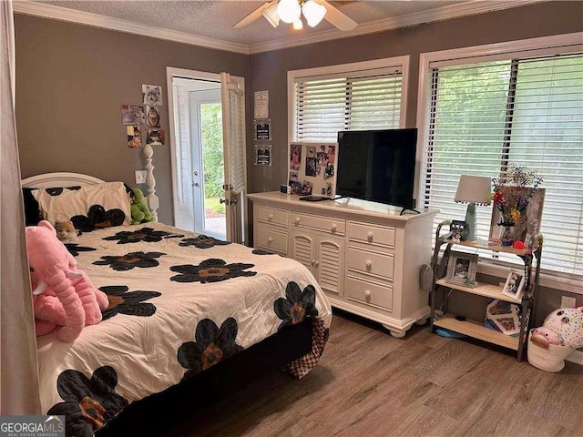 bedroom featuring access to exterior, hardwood / wood-style floors, ceiling fan, and ornamental molding