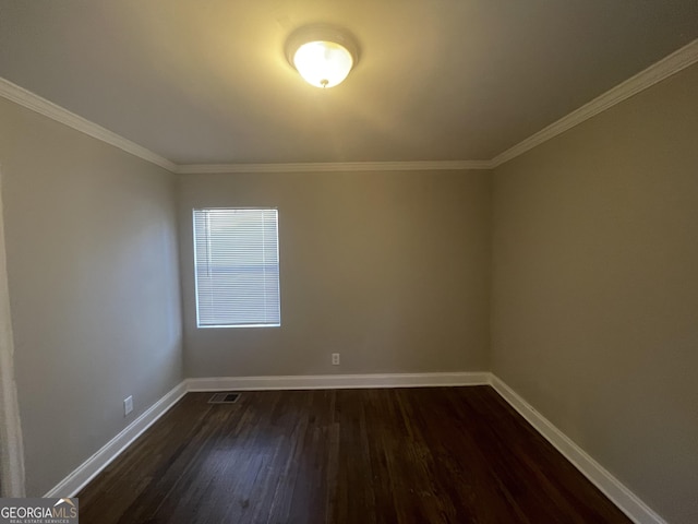 unfurnished room featuring ornamental molding and dark hardwood / wood-style flooring