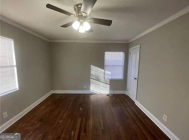 spare room with ornamental molding, ceiling fan, and dark hardwood / wood-style floors