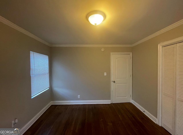 interior space with ornamental molding and dark hardwood / wood-style floors