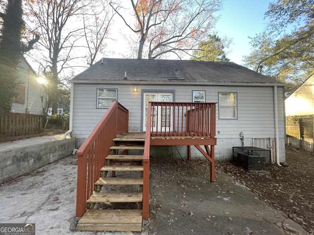 back of property with cooling unit and a wooden deck