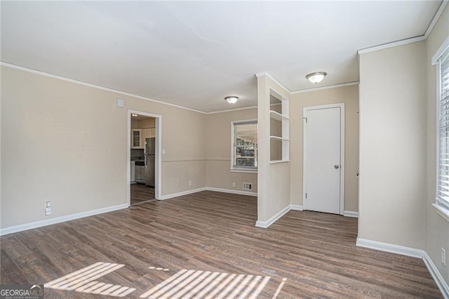 unfurnished living room with dark hardwood / wood-style flooring and crown molding