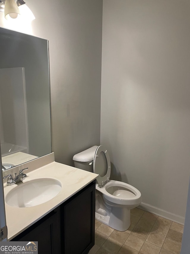 bathroom with tile patterned floors, vanity, and toilet