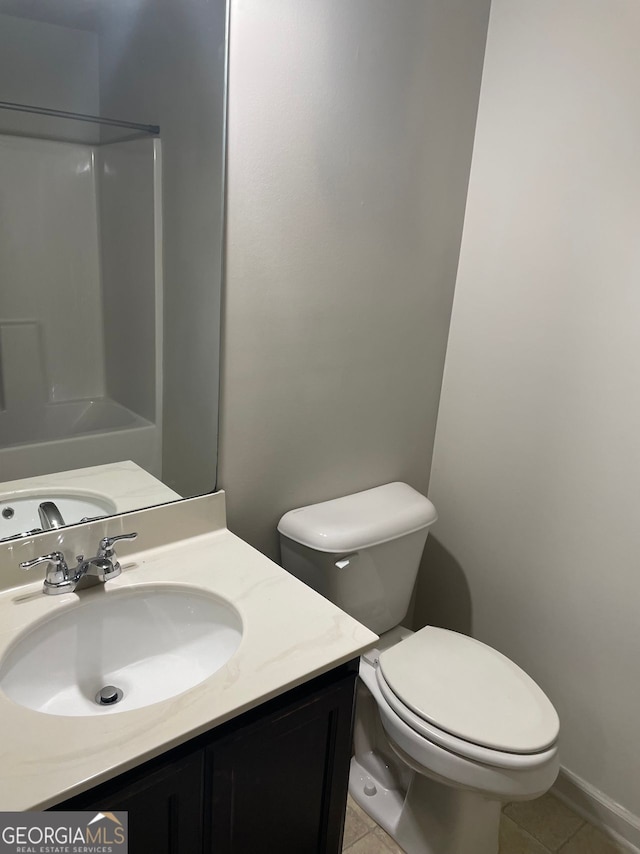 bathroom featuring toilet, vanity, and tile patterned floors