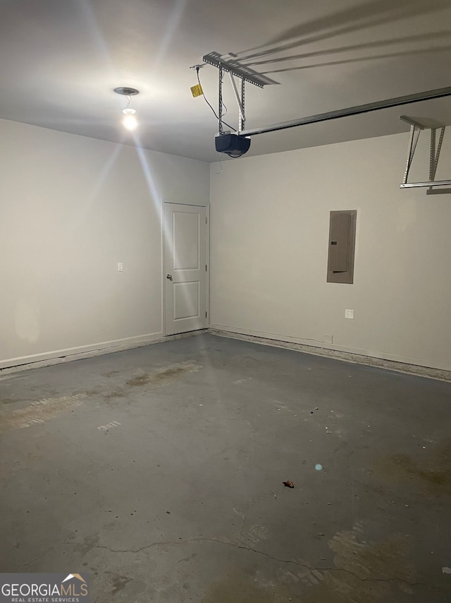 garage with electric panel and a garage door opener