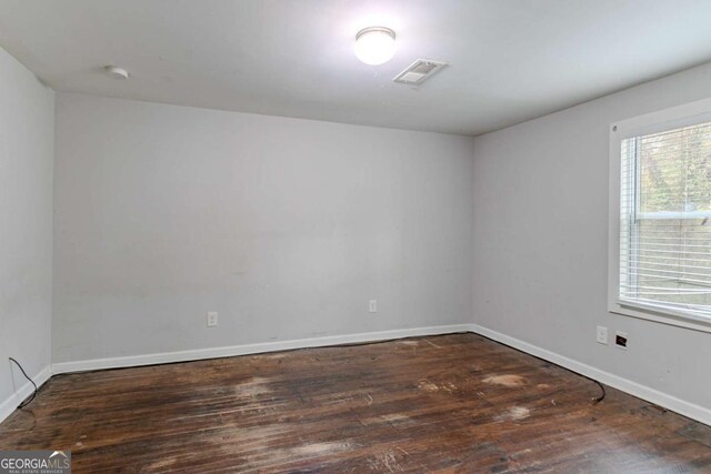 empty room with dark wood-type flooring