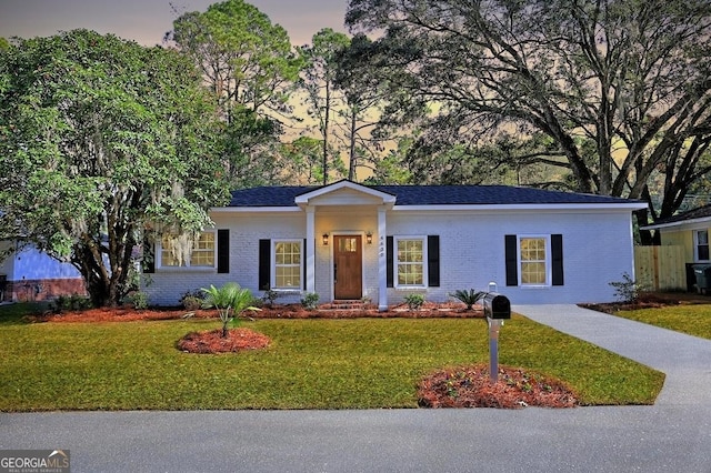 ranch-style house featuring a yard