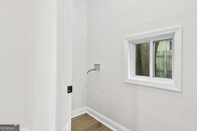 clothes washing area featuring hardwood / wood-style floors and washer hookup