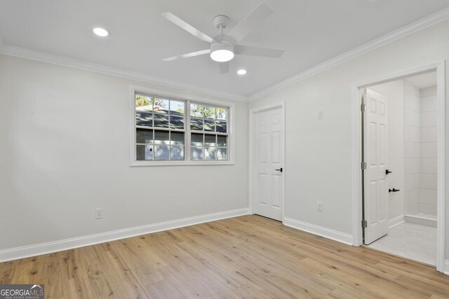 spare room featuring light hardwood / wood-style flooring, ceiling fan, and ornamental molding