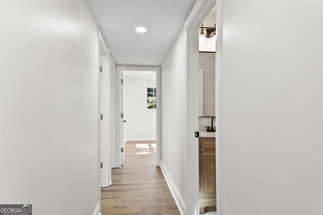 corridor with light wood-type flooring