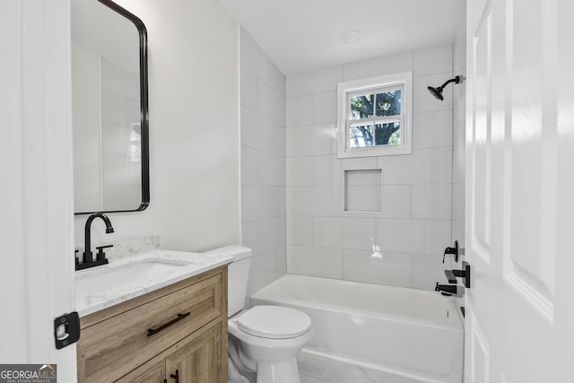 full bathroom with vanity, toilet, and tiled shower / bath