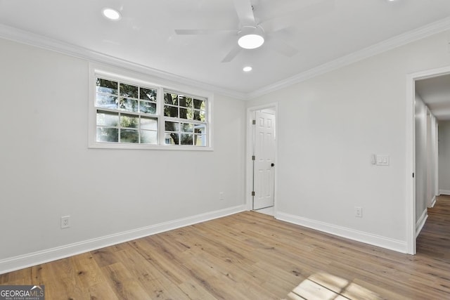 spare room featuring hardwood / wood-style floors, ceiling fan, and crown molding