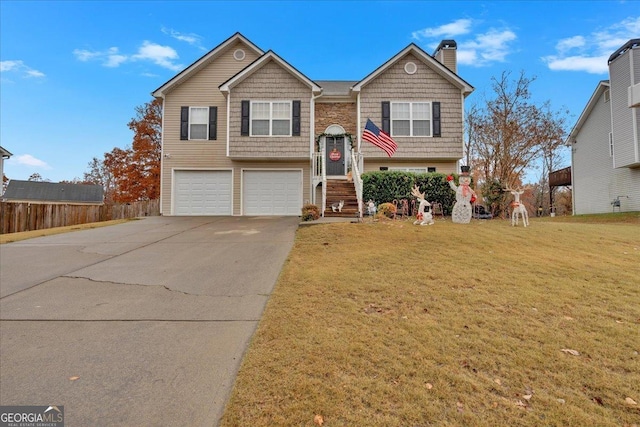 bi-level home featuring a garage and a front yard