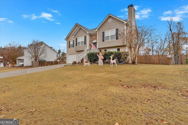 view of front of property with a garage and a front lawn