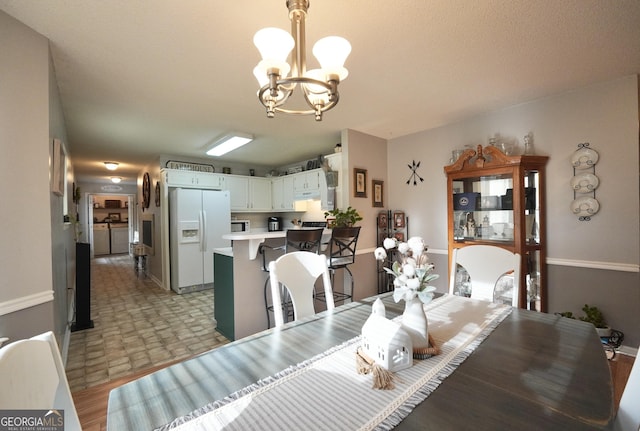 dining space featuring a notable chandelier