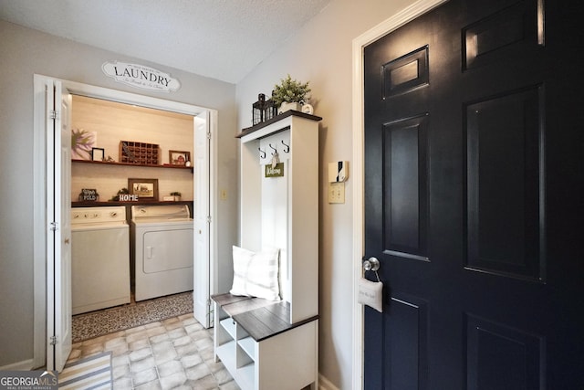 interior space featuring a textured ceiling and washing machine and dryer