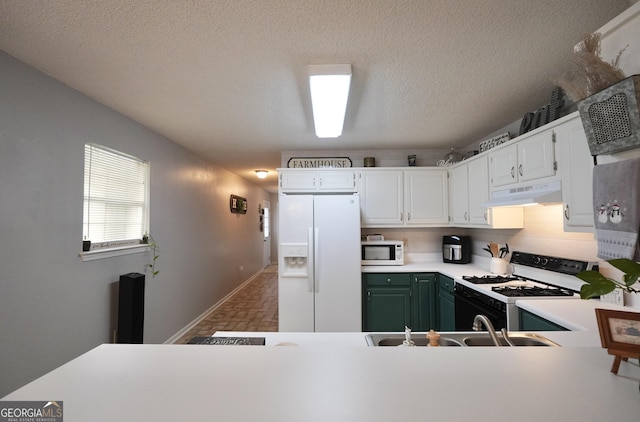 kitchen featuring white cabinets, a textured ceiling, white appliances, and green cabinetry