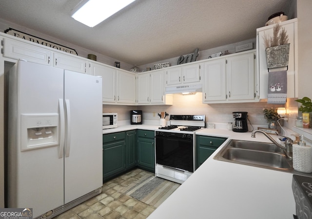 kitchen with white appliances, sink, green cabinetry, a textured ceiling, and white cabinetry