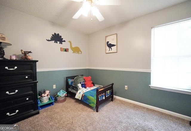 bedroom with carpet, ceiling fan, and multiple windows