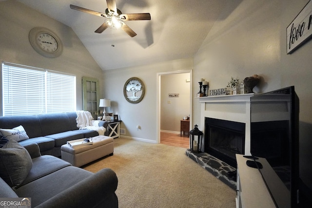 living room with high vaulted ceiling, ceiling fan, a fireplace, and light carpet