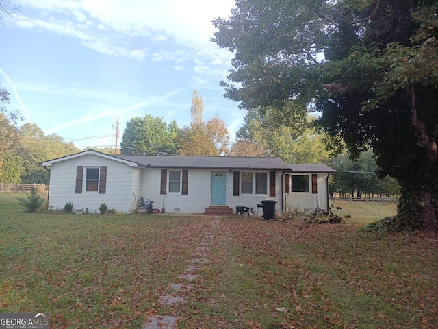 ranch-style home with entry steps, crawl space, brick siding, and a front lawn