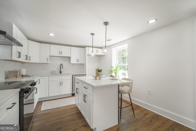 kitchen with white cabinets, a center island, and appliances with stainless steel finishes