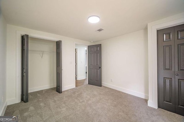 unfurnished bedroom featuring light colored carpet