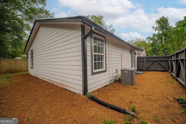 view of side of home with central air condition unit