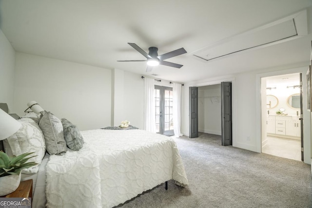 carpeted bedroom featuring ceiling fan, ensuite bathroom, and a closet