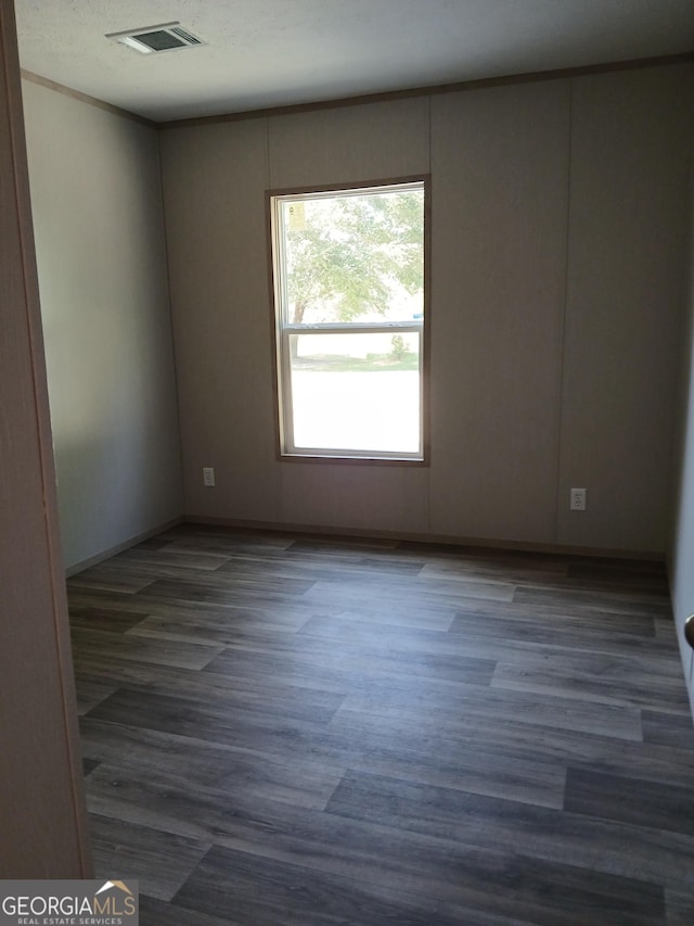 spare room with dark hardwood / wood-style floors