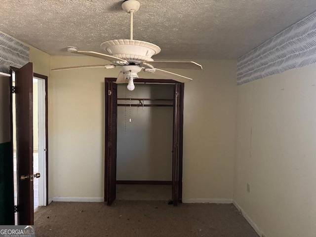 unfurnished bedroom with a textured ceiling, a closet, ceiling fan, and carpet floors