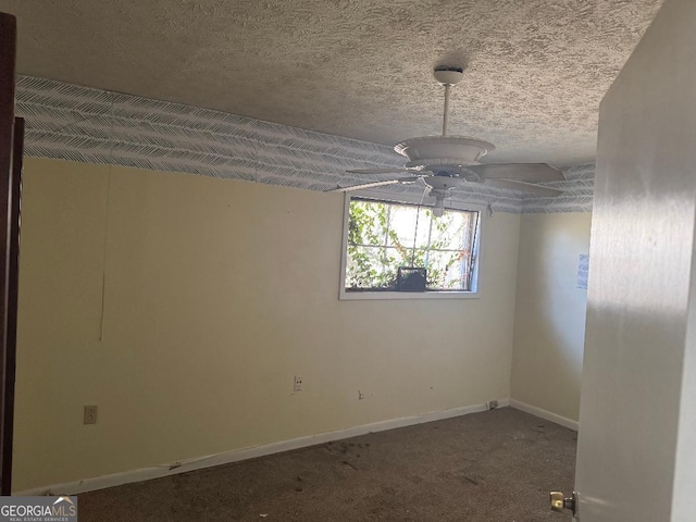 carpeted empty room with ceiling fan and a textured ceiling