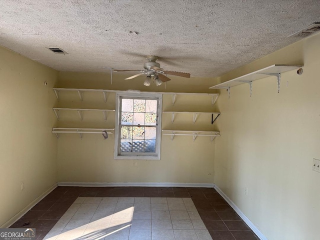 interior space featuring ceiling fan and dark tile patterned floors